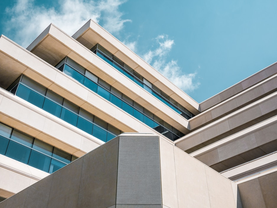 A light colored office building photographed from below.